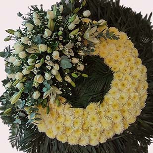 corona funebre grande de 1.20 m. de diametro con rosas blancas, lilis blancas,pompones,montecasino, palma, follaje verde